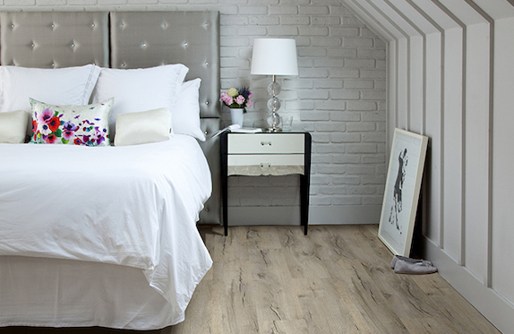 gorgeous luxury vinyl plank flooring in a charming rustic bedroom